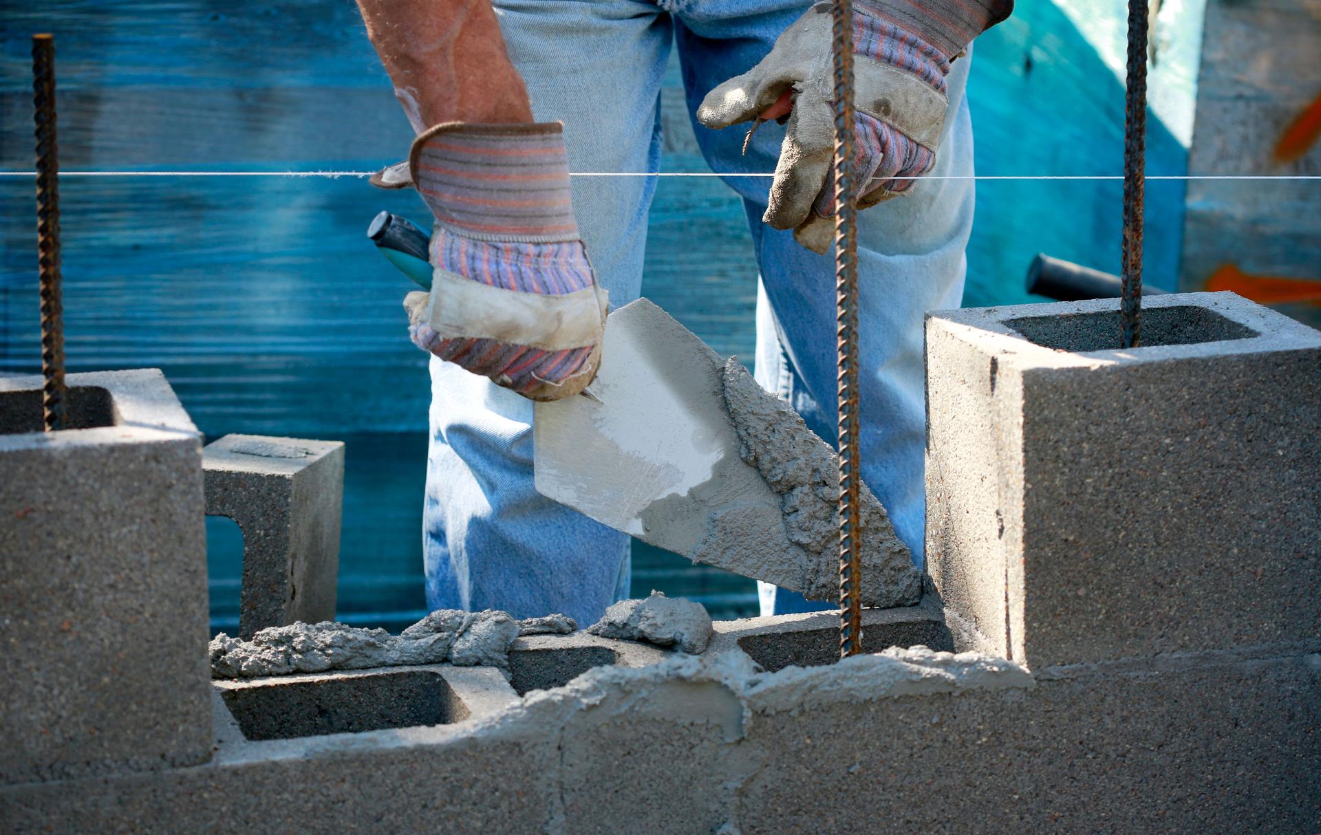 Mason in laying concrete blocks